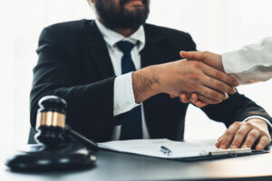 A lawyer shakes hand with a client on an agreement about a passport data breach claim.